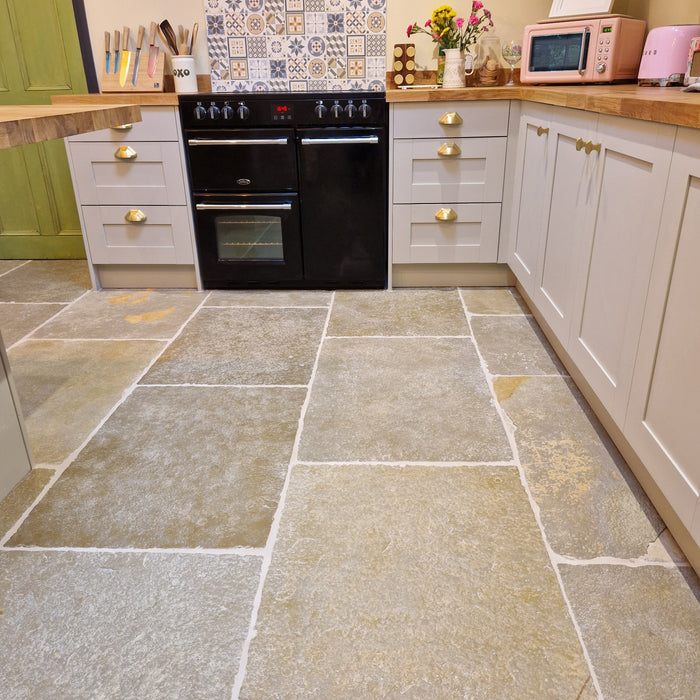 Natural Stone Online Minster Antiqued Limestone tiles country neutral home with Smeg appliances and mosaic tile splashback