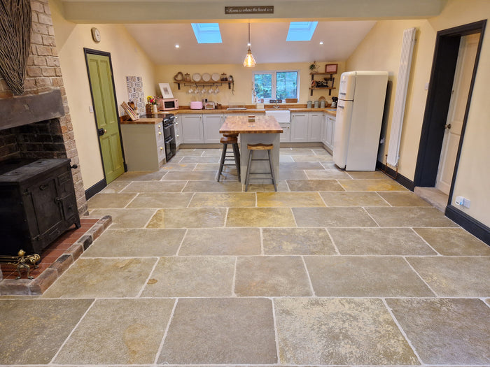 Natural Stone Online Minster Antiqued Limestone tiles country neutral home with Smeg appliances and exposed brick fireplace stove and kitchen island