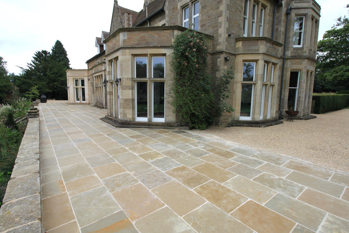Natural Stone Online Minster Antiqued Limestone exterior paving tiles on the grounds of a stately home 